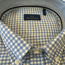 Load image into Gallery viewer, Close-up of a blue and white checkered shirt with a brand label.
